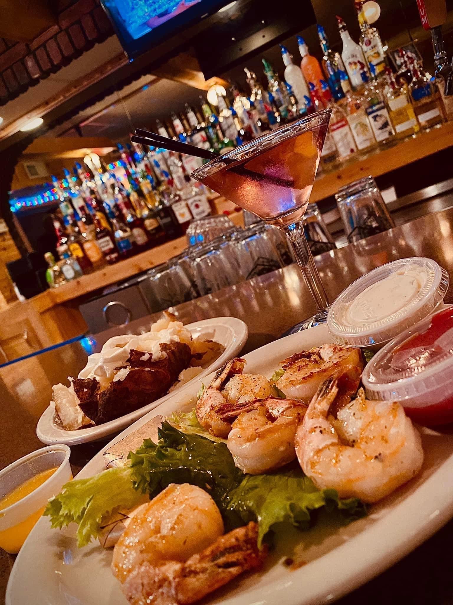 Grilled shrimp and a steak plate on the bar, from the House of Coates Facebook page.